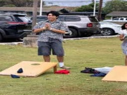 WHM Jr. YBA member, Kamauoha, runs the Cornhole game for competition against temples