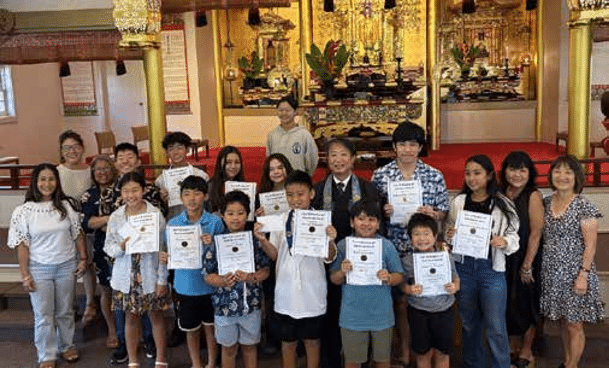 Dharma School students stand with their teachers and Rev. Shinkai Murakami.